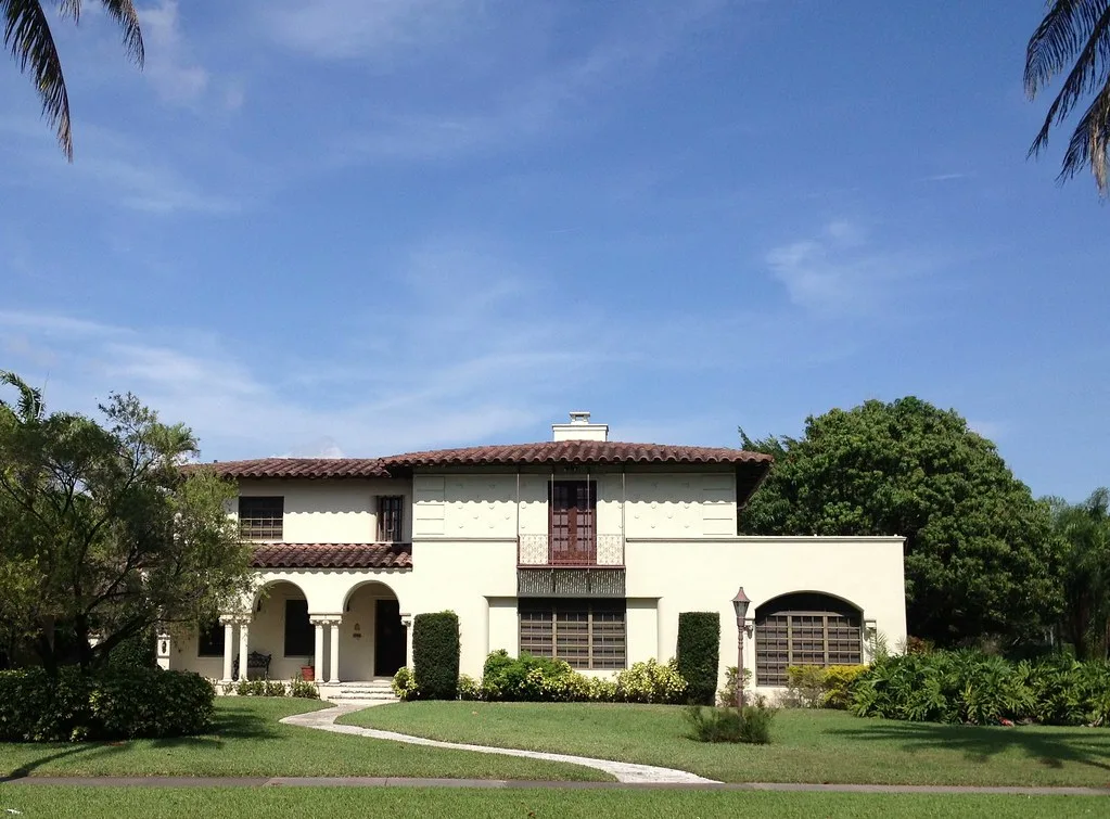 A two-story Mediterranean Revival house with a tile roof across from Granada Golf Course in Coral Gables.