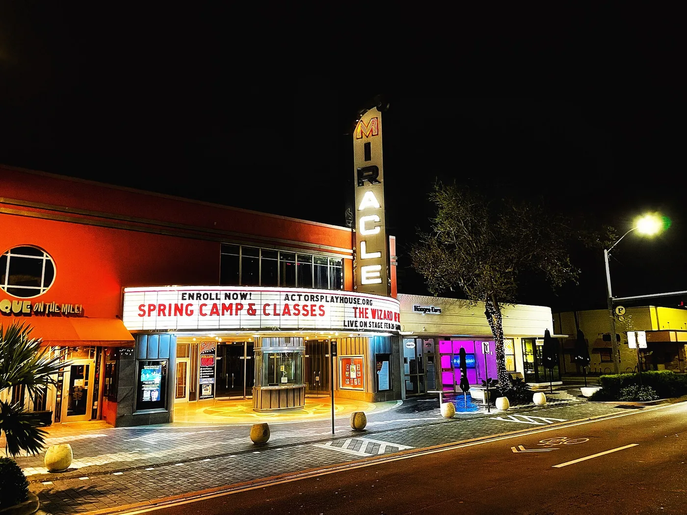 The Miracle Theatre's marquee lit at night on Miracle Mile in Coral Gables, home of Actors' Playhouse.