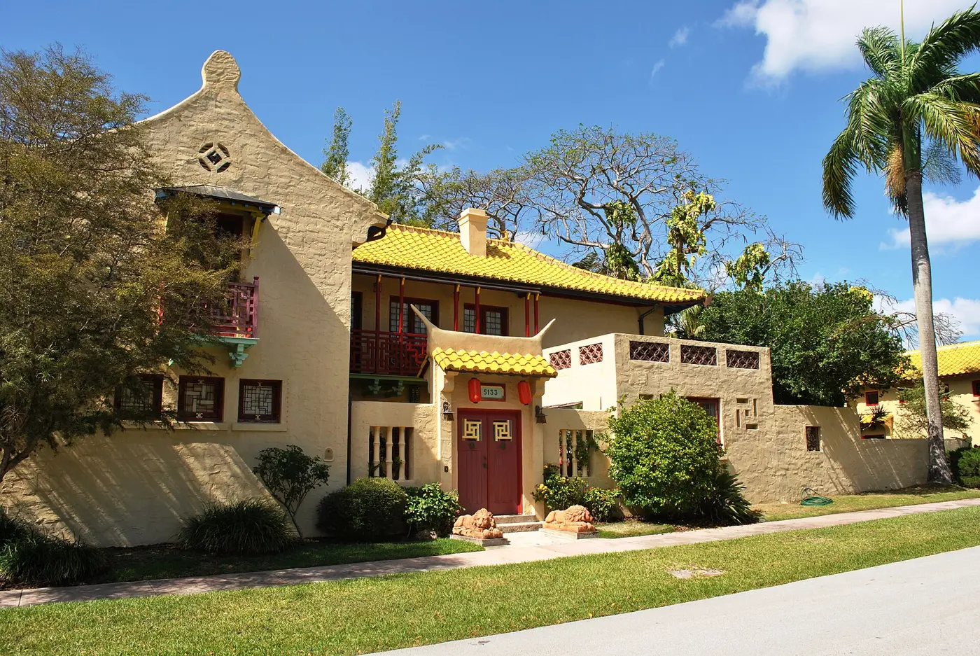 A Mediterranean Revival house with a yellow tile roof in Coral Gables.