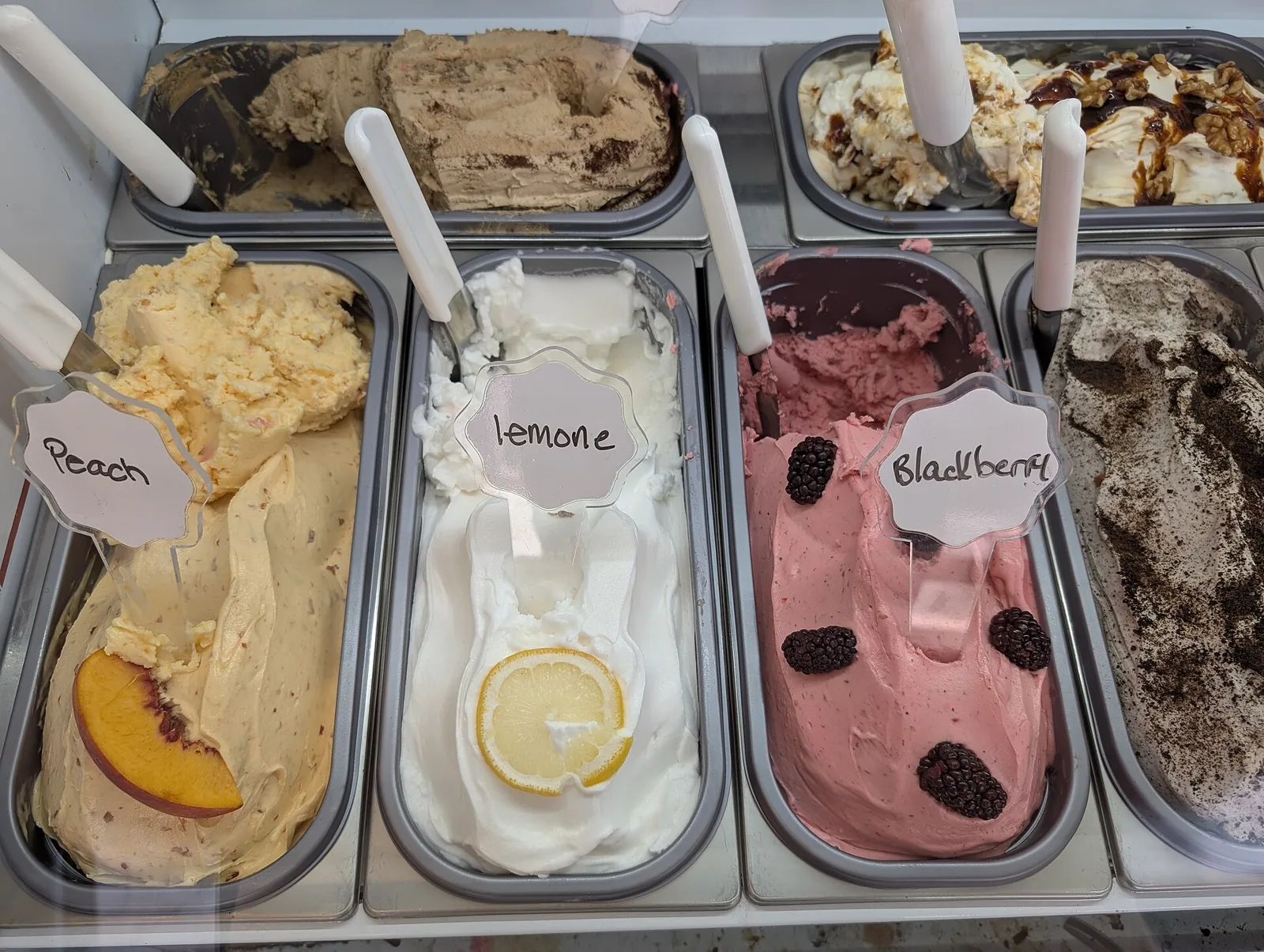 Trays of gelato in a shop case. The photo was not taken in Coral Gables.