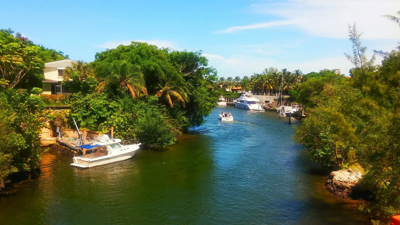 A waterway lined with docks beside Cartagena Plaza, at the north edge of Cocoplum