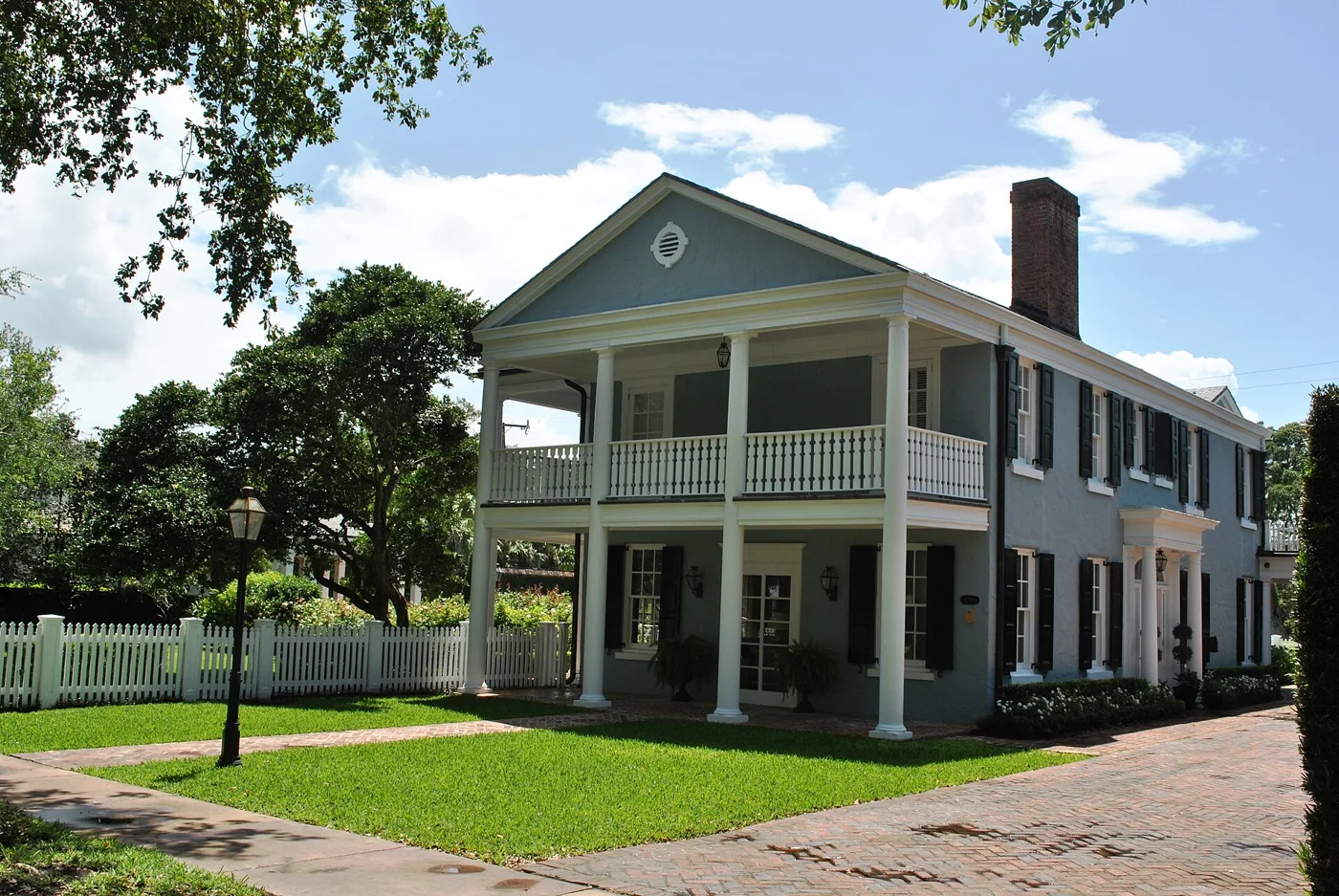 A two-story house on a brick driveway in Coral Gables.