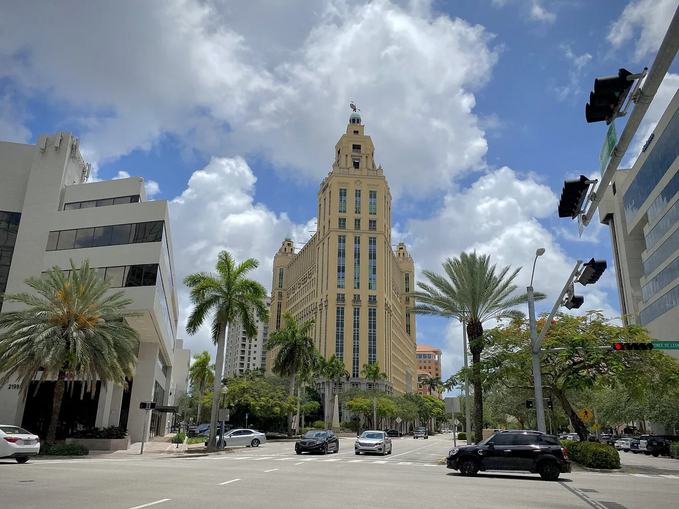 Palms and office towers at a downtown Coral Gables intersection.